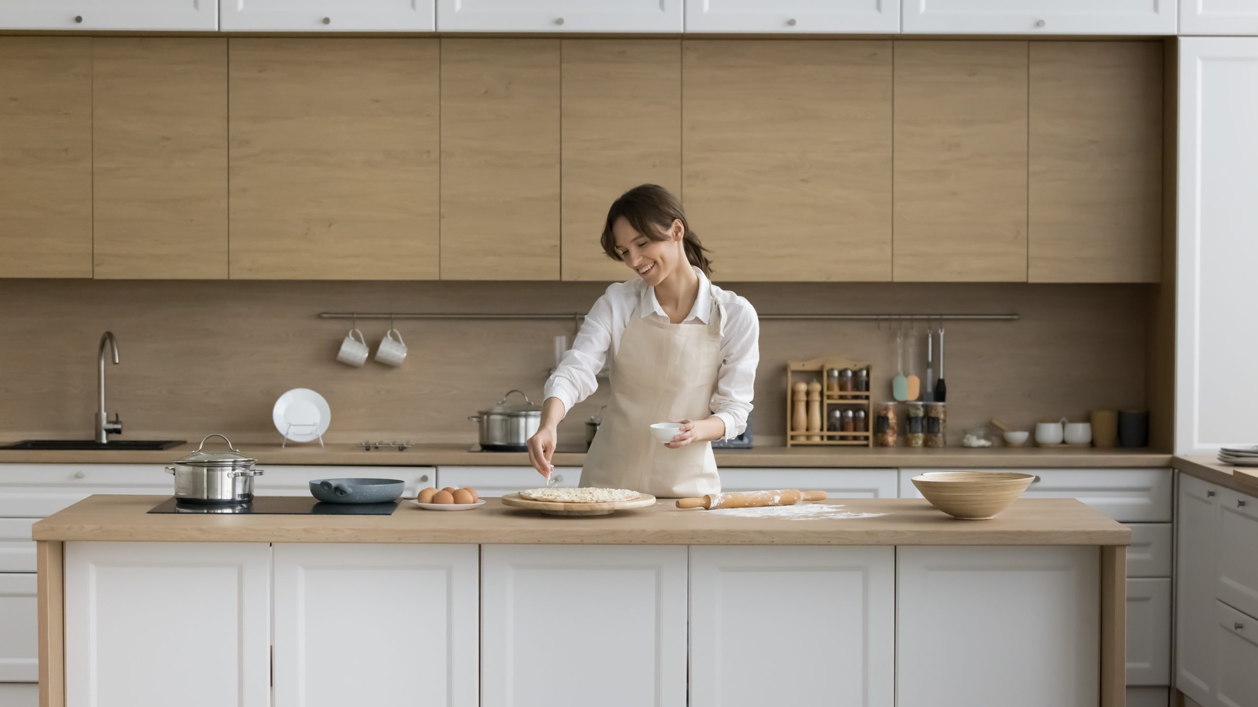 Young,Female,Wear,Apron,Cooking,Pizza,,Sprinkle,Dish,With,Cheese,