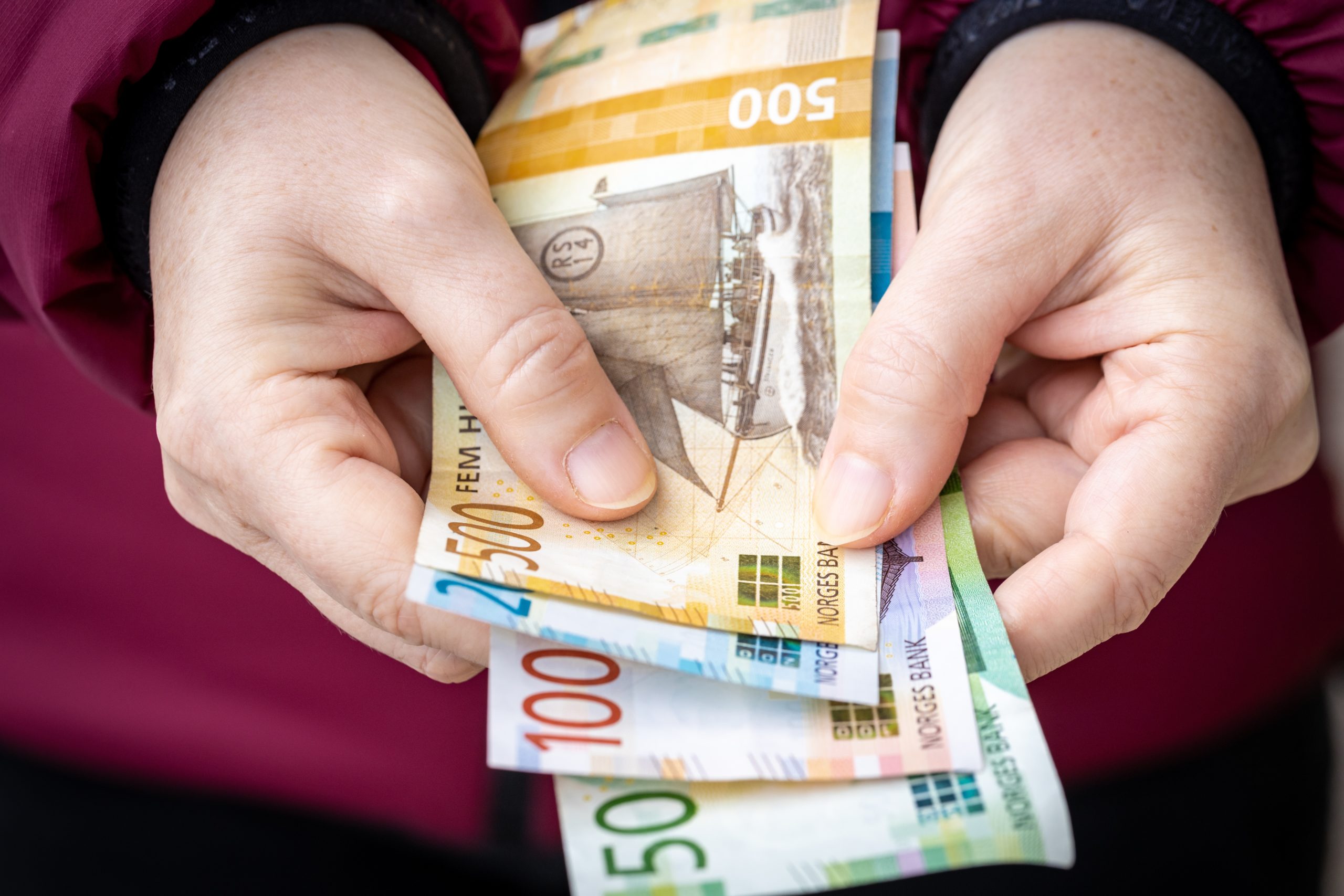 Woman,Converting,Money,On,The,Street,Norwegian,Krone,,Financial,Concept
