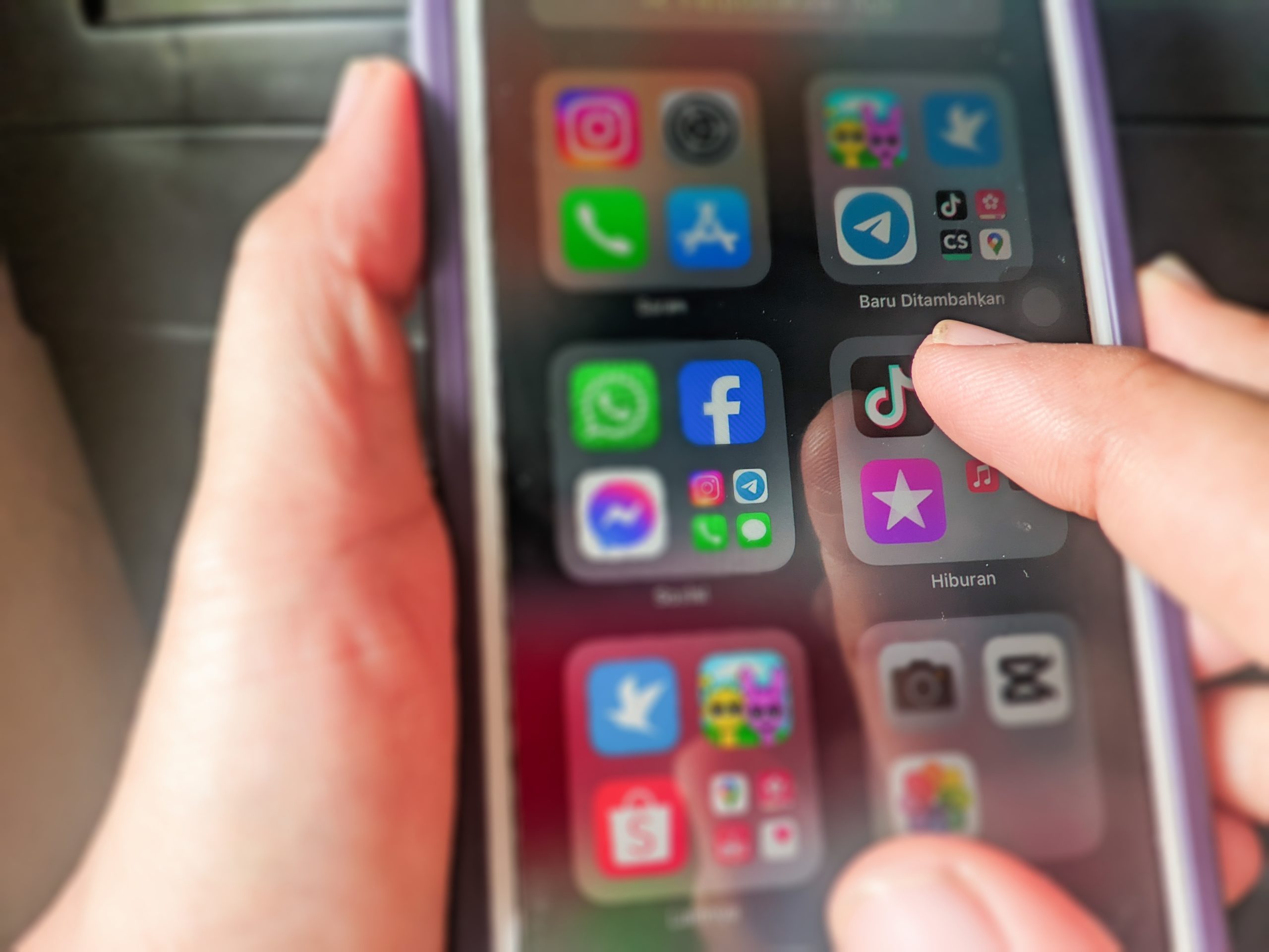 A,Hand,Is,Holding,An,Iphone,To,Open,The,Tiktok A,Hand,Is,Holding,An,Iphone,To,Open,The,Tiktok